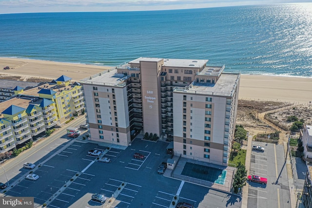 drone / aerial view featuring a view of the beach and a water view