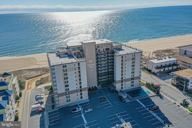 drone / aerial view with a water view and a view of the beach