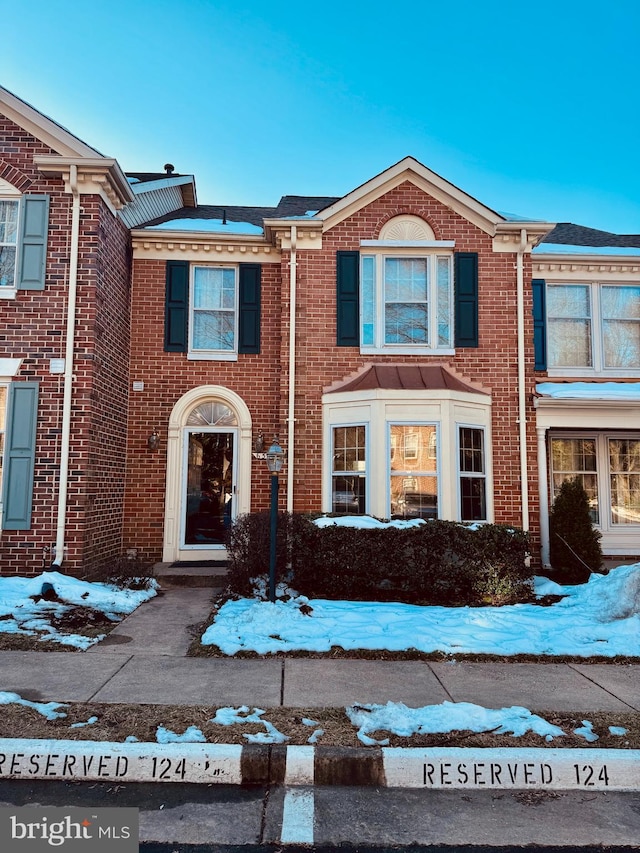 view of property featuring brick siding