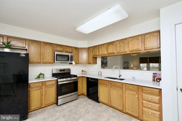 kitchen with black appliances, light countertops, brown cabinets, and a sink