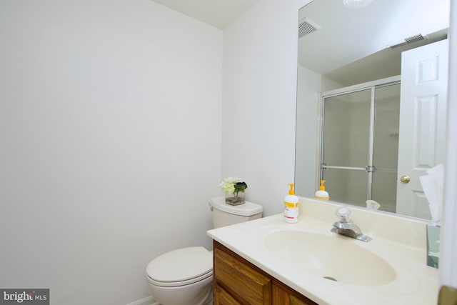 full bathroom featuring visible vents, toilet, a stall shower, and vanity