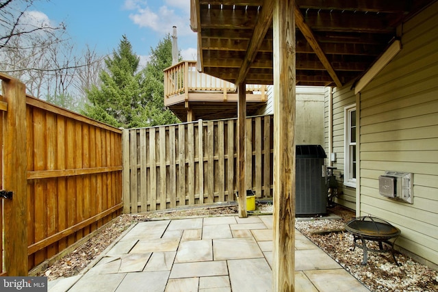 view of patio / terrace with cooling unit and a fenced backyard