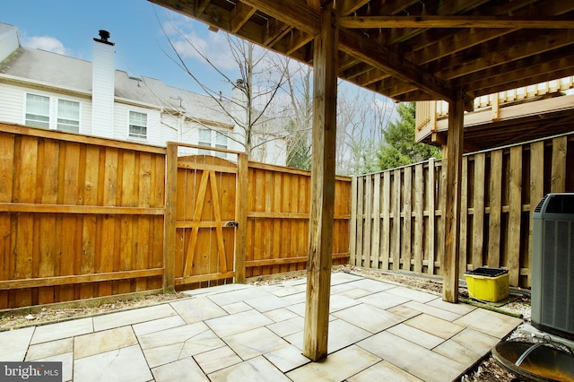 view of patio / terrace featuring a gate, central AC unit, and fence