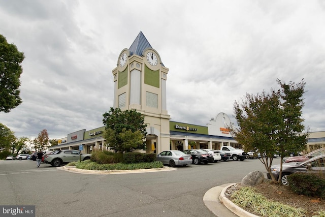 view of building exterior with uncovered parking