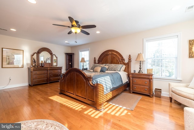 bedroom with ceiling fan and light hardwood / wood-style floors