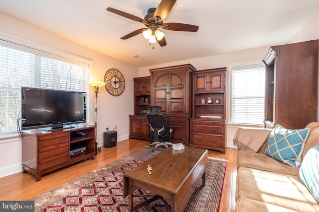 living room featuring ceiling fan and light hardwood / wood-style floors