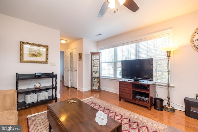 living room with ceiling fan and hardwood / wood-style floors