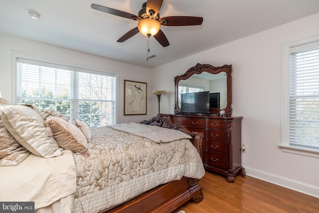 bedroom with ceiling fan and light hardwood / wood-style flooring