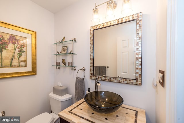 bathroom featuring toilet and vanity