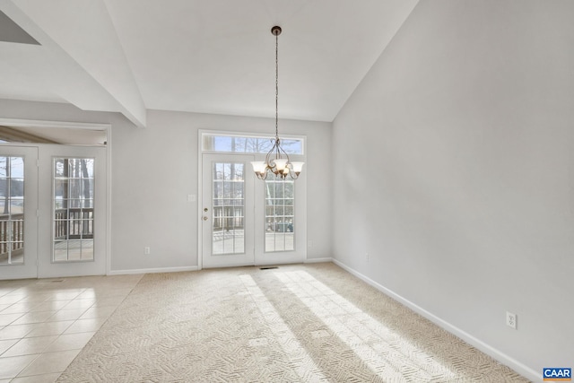 unfurnished dining area with a notable chandelier, a wealth of natural light, and light tile patterned flooring