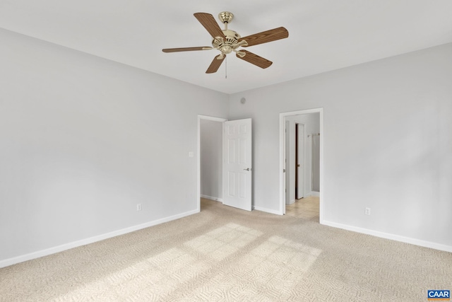 carpeted spare room featuring ceiling fan