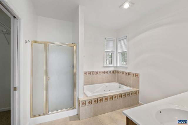 bathroom featuring tile patterned flooring, shower with separate bathtub, and vanity