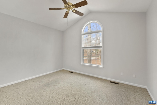 carpeted spare room featuring lofted ceiling and ceiling fan