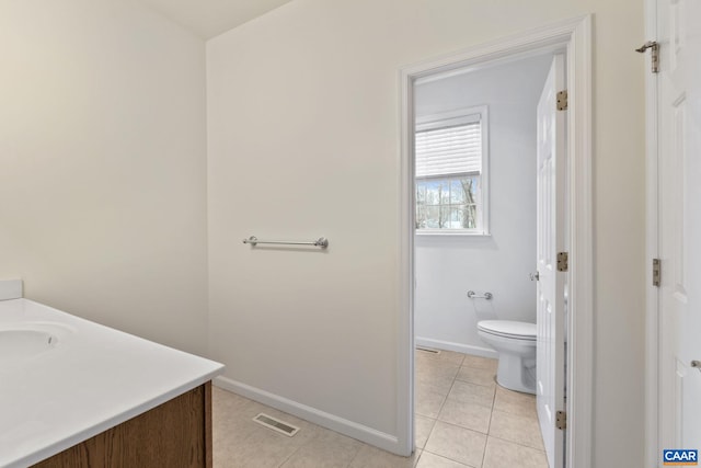 bathroom with tile patterned floors, vanity, and toilet