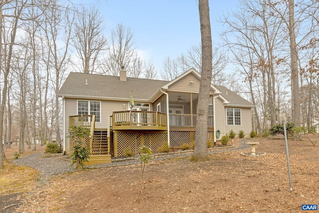 rear view of property featuring ceiling fan and a deck