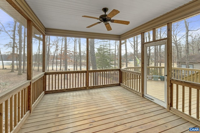 unfurnished sunroom featuring ceiling fan