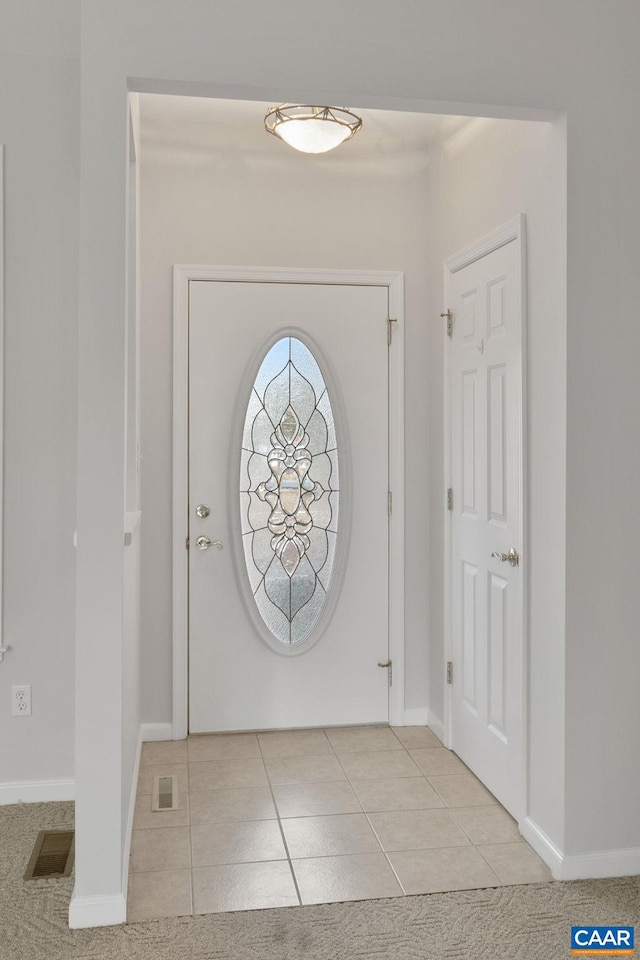 foyer entrance with light tile patterned flooring