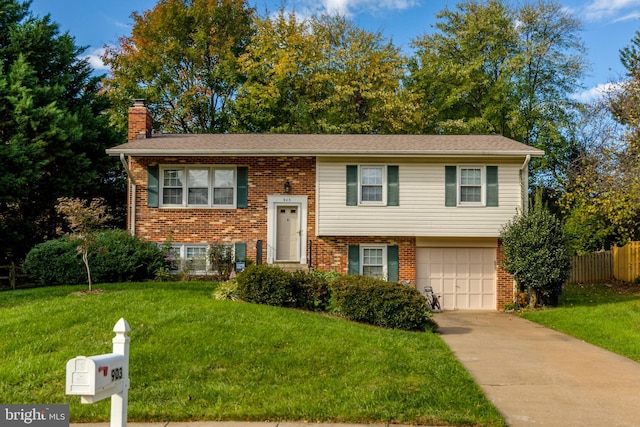 raised ranch with a front yard and a garage