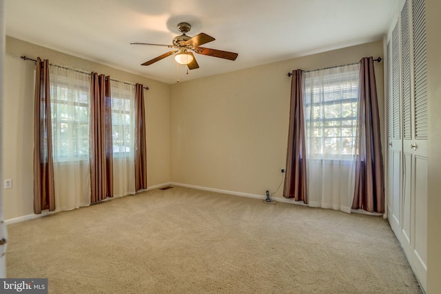 carpeted empty room with ceiling fan