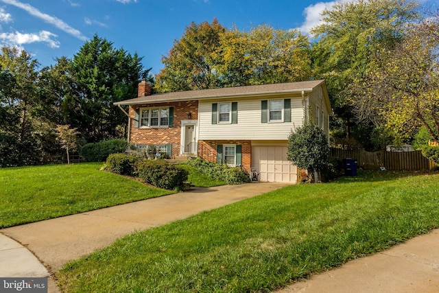 raised ranch with a garage and a front yard