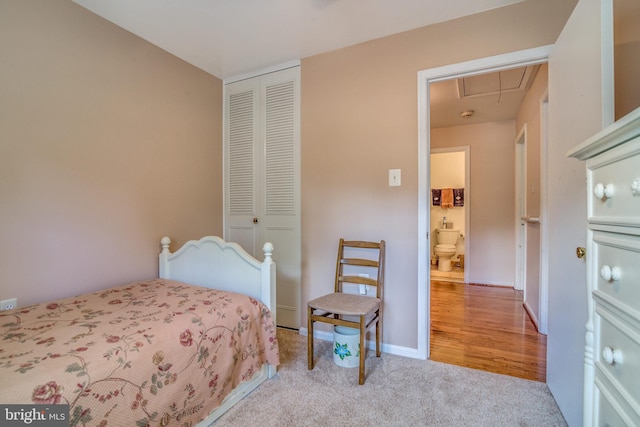 bedroom featuring a closet and light colored carpet