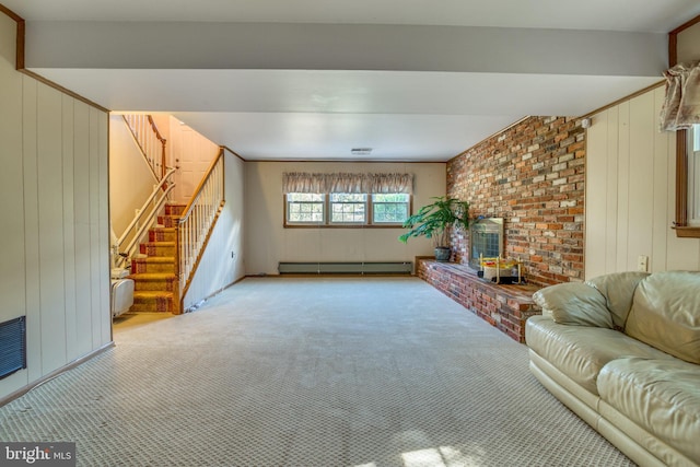 living room with a baseboard heating unit, light carpet, and wooden walls