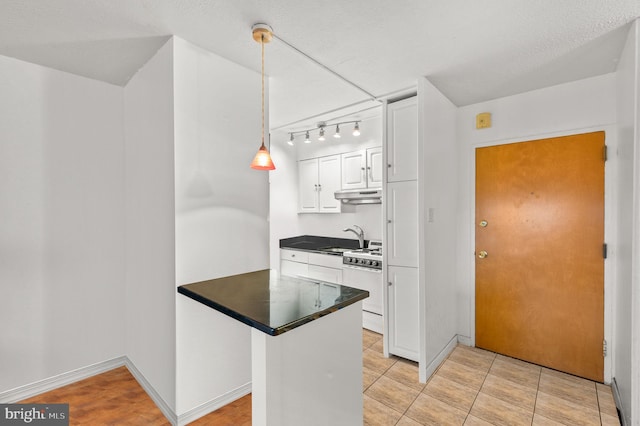 kitchen with kitchen peninsula, sink, white cabinetry, white range with gas cooktop, and hanging light fixtures