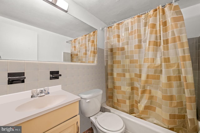 full bathroom featuring vanity, toilet, tile walls, and shower / tub combo