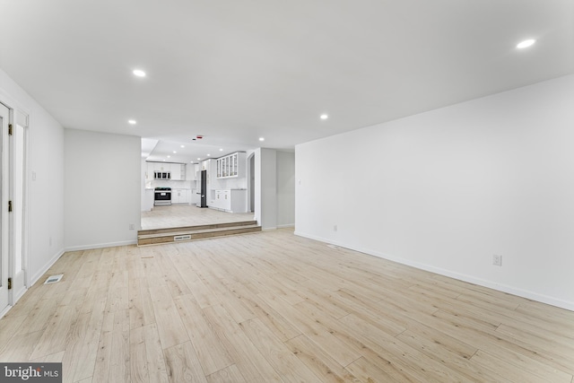 unfurnished living room featuring light wood-type flooring