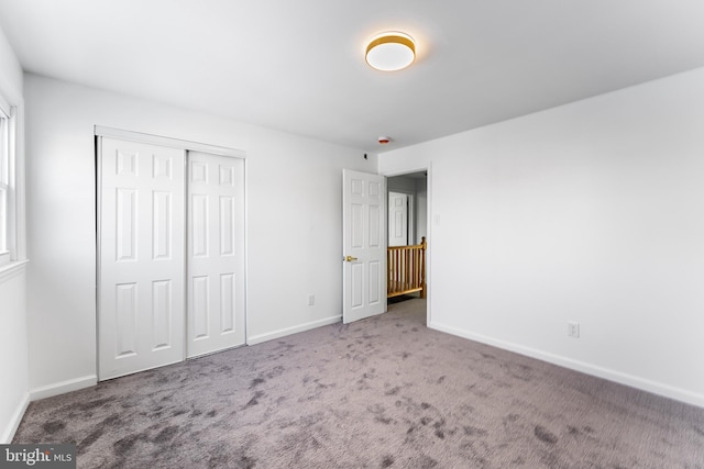 unfurnished bedroom with carpet floors and a closet