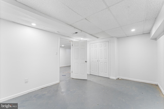 basement featuring a paneled ceiling