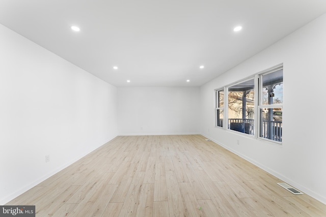 empty room with light hardwood / wood-style floors