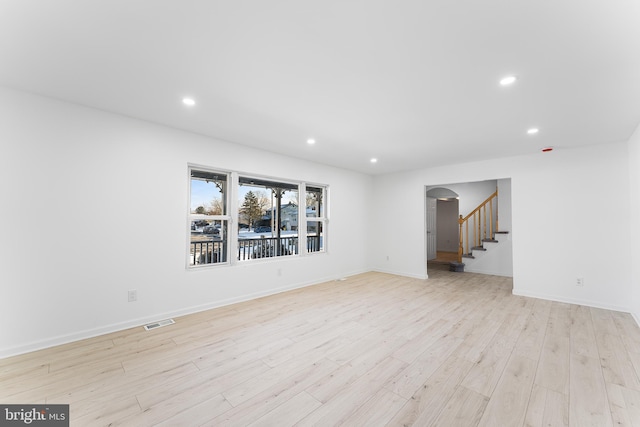 unfurnished room with light wood-type flooring