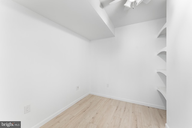 walk in closet with ceiling fan and light hardwood / wood-style flooring