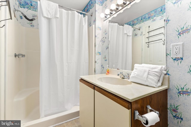 bathroom with walk in shower and vanity