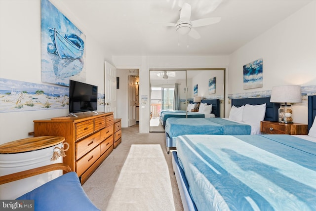 carpeted bedroom with a closet and ceiling fan