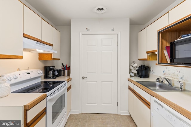 kitchen with white cabinets, white appliances, and sink