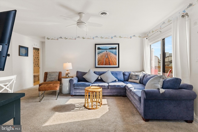 living room with ceiling fan and light carpet