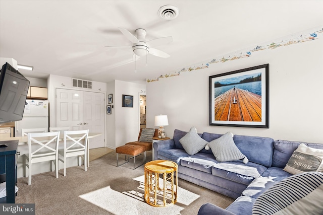 living room featuring ceiling fan and light colored carpet