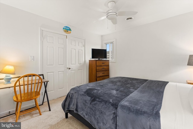 carpeted bedroom with a closet and ceiling fan