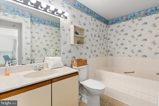 bathroom featuring vanity, toilet, and tiled bath