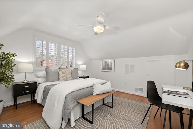 bedroom featuring ceiling fan, dark hardwood / wood-style flooring, and vaulted ceiling