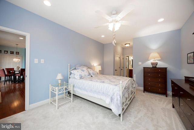 carpeted bedroom with ceiling fan and a closet