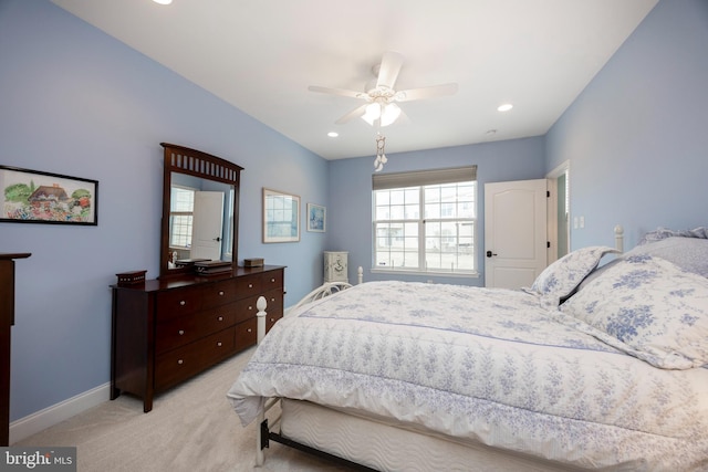 bedroom with ceiling fan and light carpet