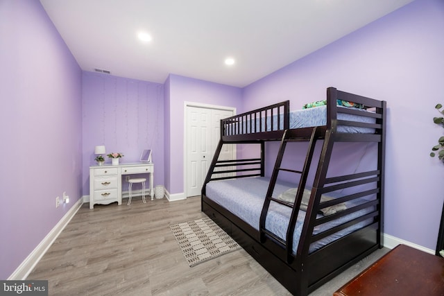 bedroom featuring wood-type flooring and a closet