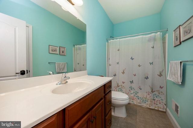 bathroom featuring toilet, walk in shower, and vanity