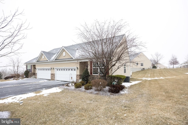 view of front of property featuring a garage and a front lawn