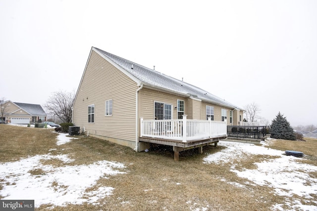 snow covered property featuring a deck and central AC unit