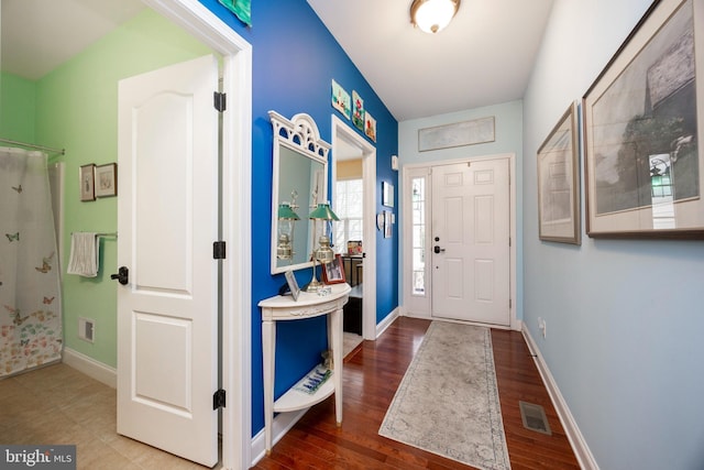 foyer entrance with hardwood / wood-style floors