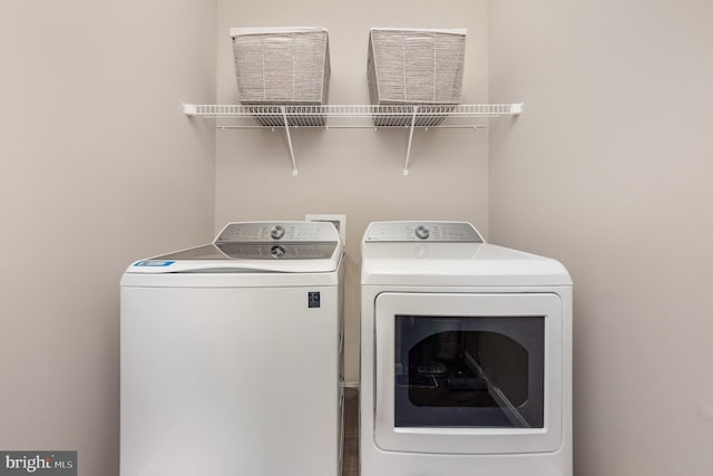 laundry room featuring washing machine and clothes dryer